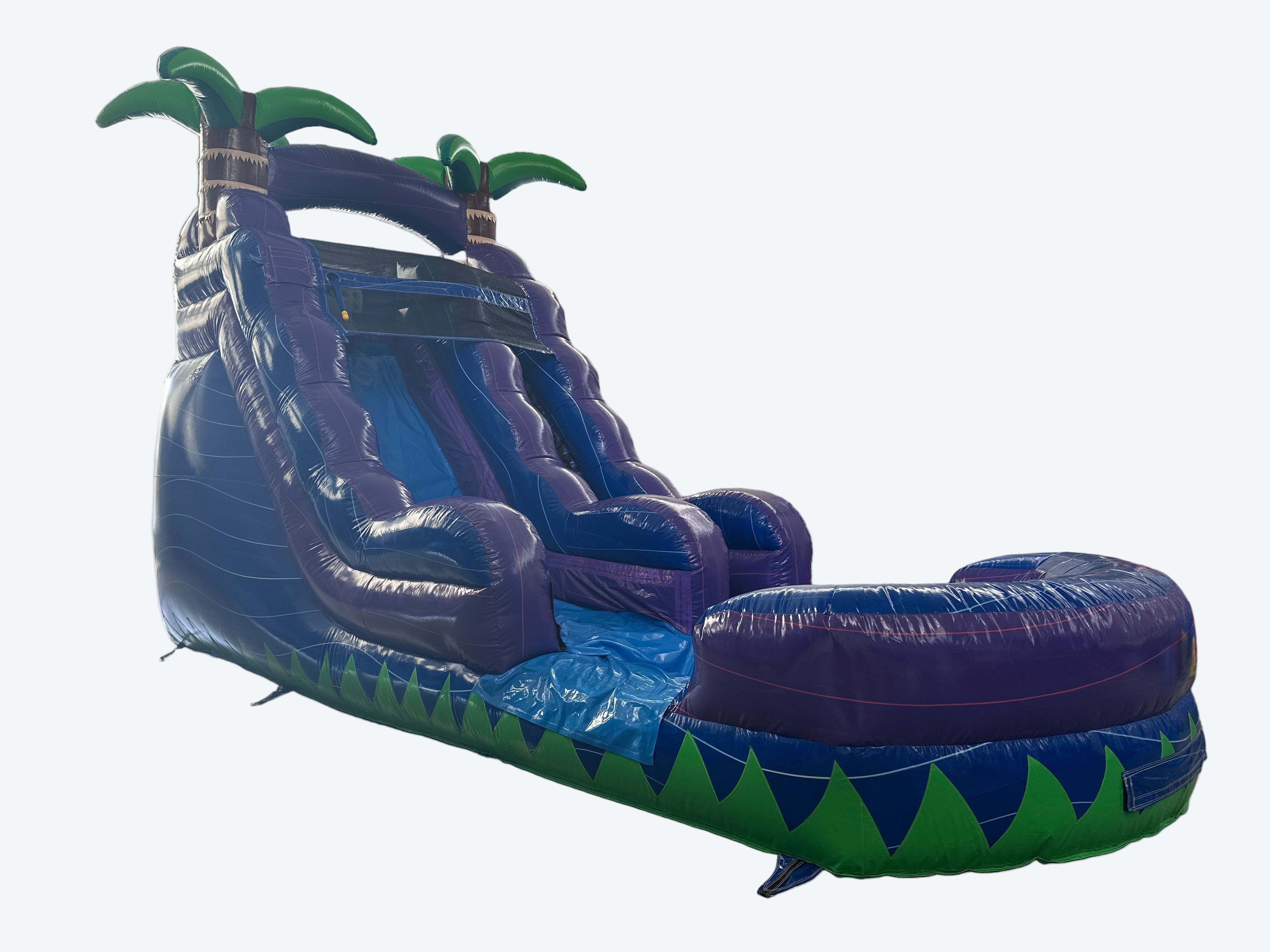 Inflatable water slide with palm tree design in an indoor setting